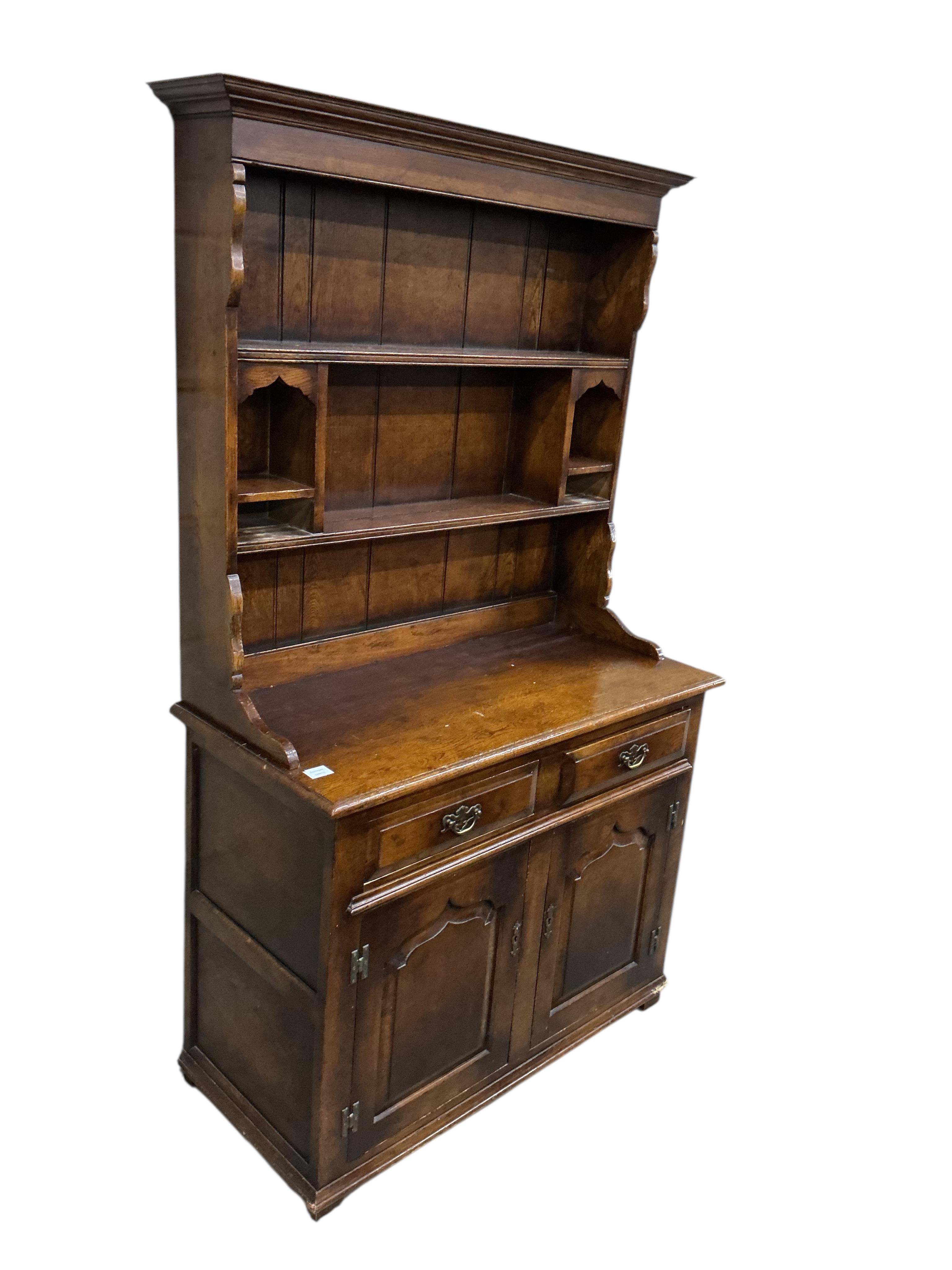 A small 18th century style oak dresser with boarded rack, width 105cm, depth 49cm, height 183cm